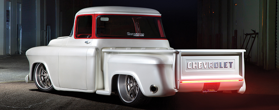 white '57 Chevy rear view with bumper lights at night