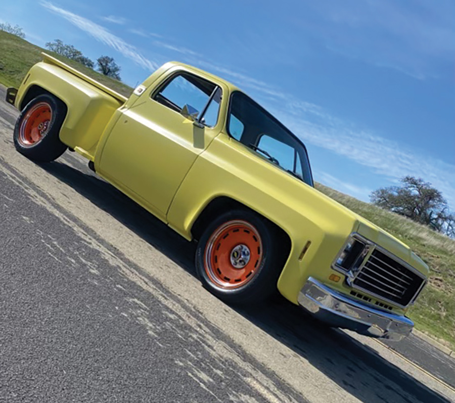 An angle view photograph perspective of a 1974 Chevrolet Stepside Pickup Truck parked on the road