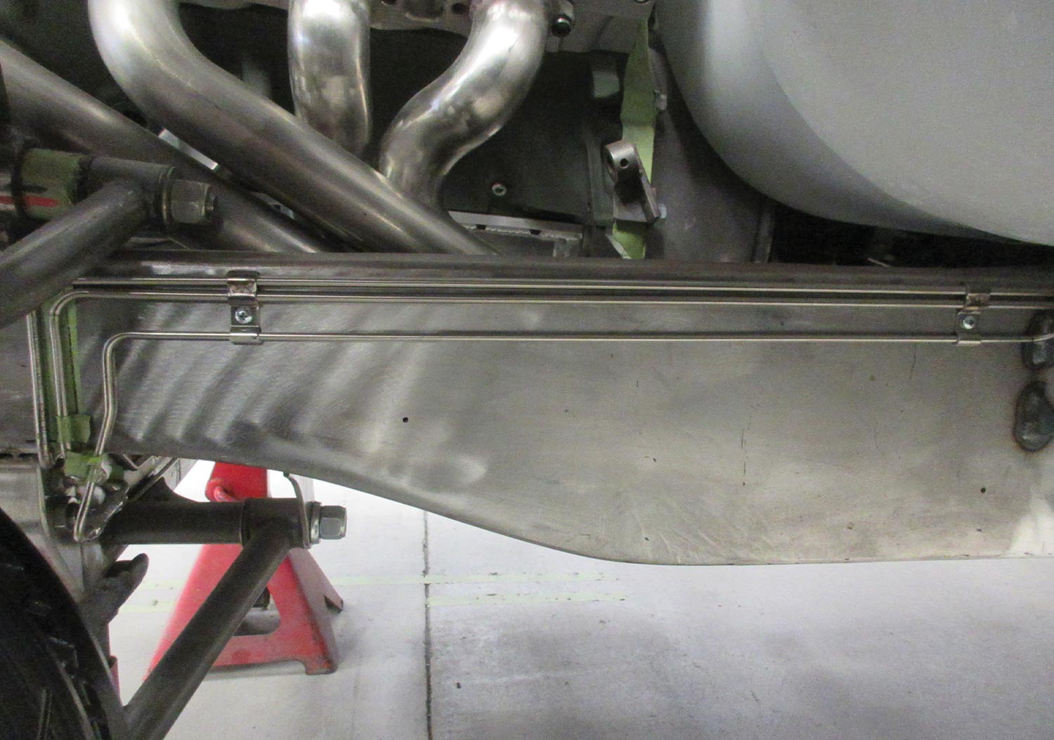 close view of the brake lines beneath the car