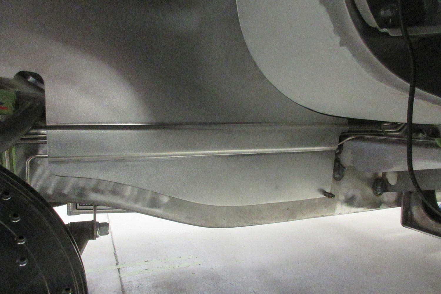 with the panel mounted, you can see how the channel neatly encloses the brake lines