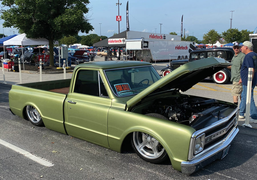 Green classic pickup truck with the hood opened