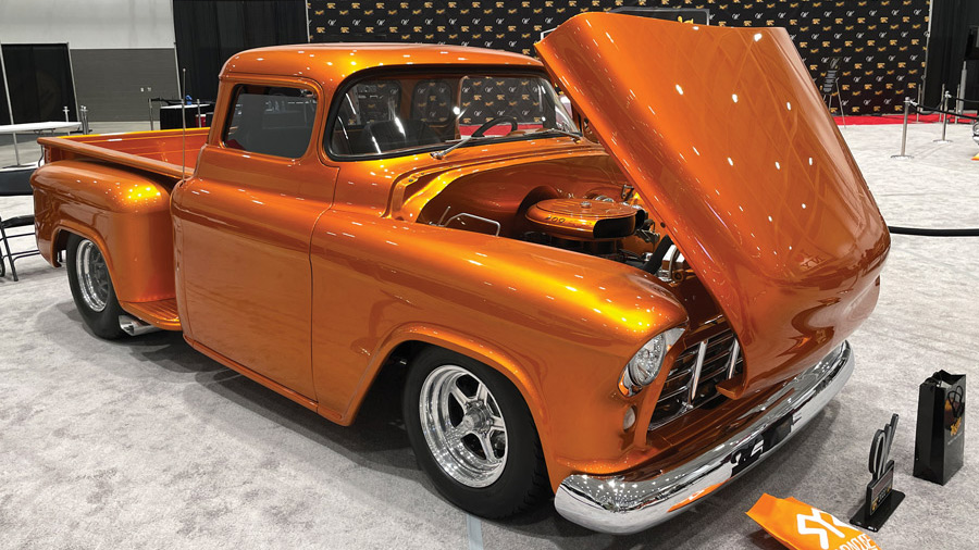 Shiny orange classic pick up truck with the hood opened
