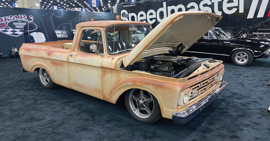 rusted white classic pickup with the hood opened