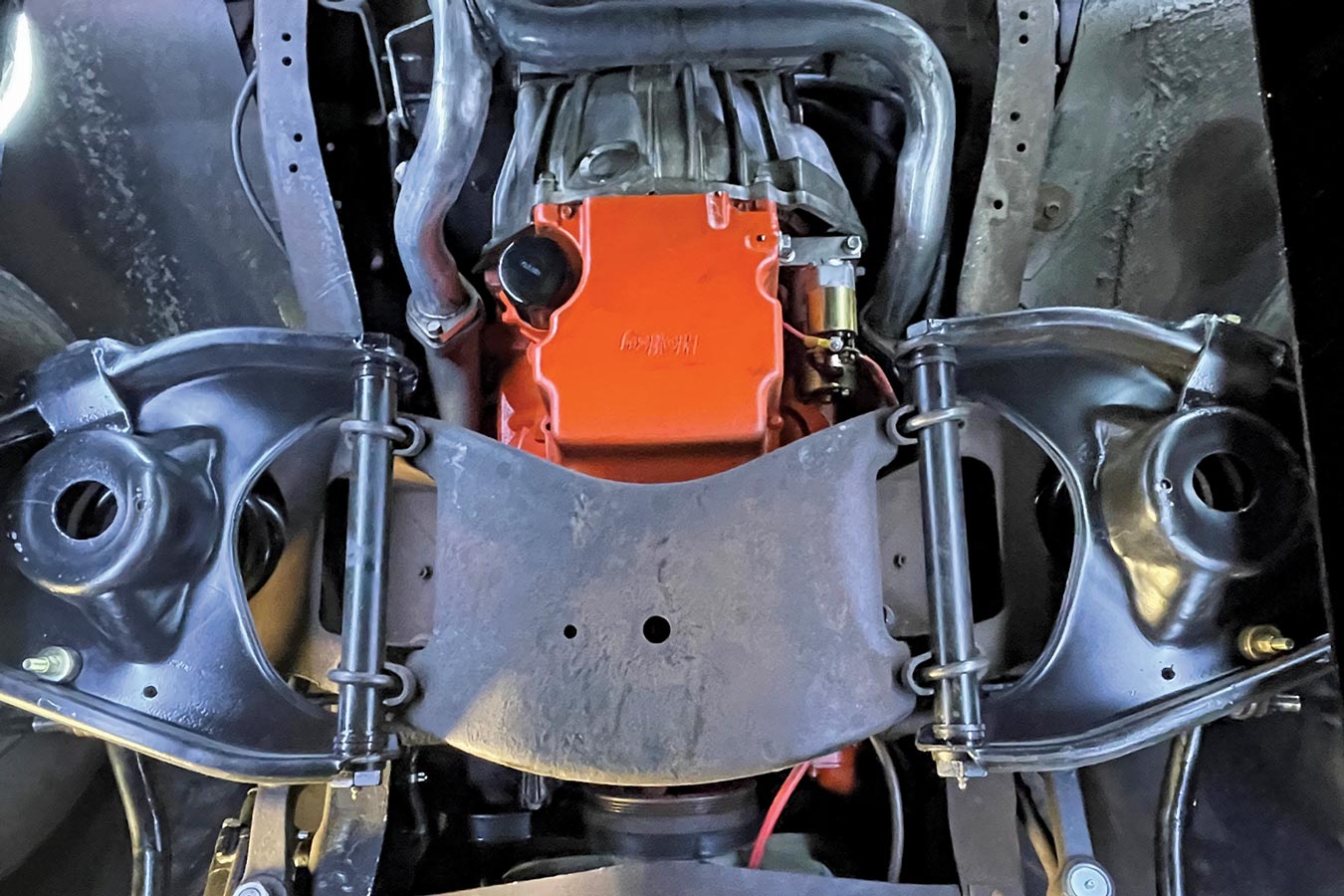 a worm’s-eye view of the original C10 suspension—the stock front crossmember