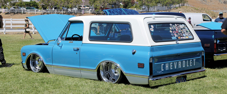 blue truck with hood open and white camper shell