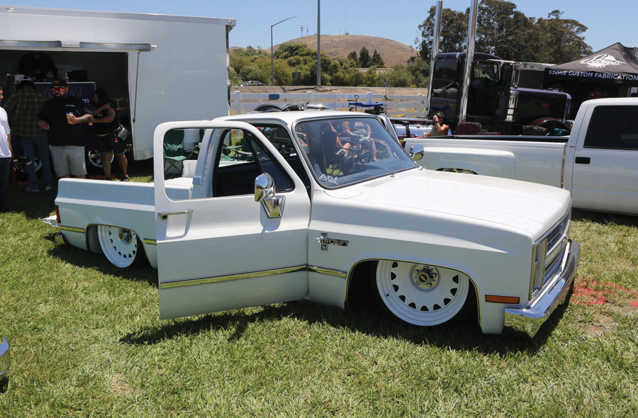 white truck with doors opened at an event
