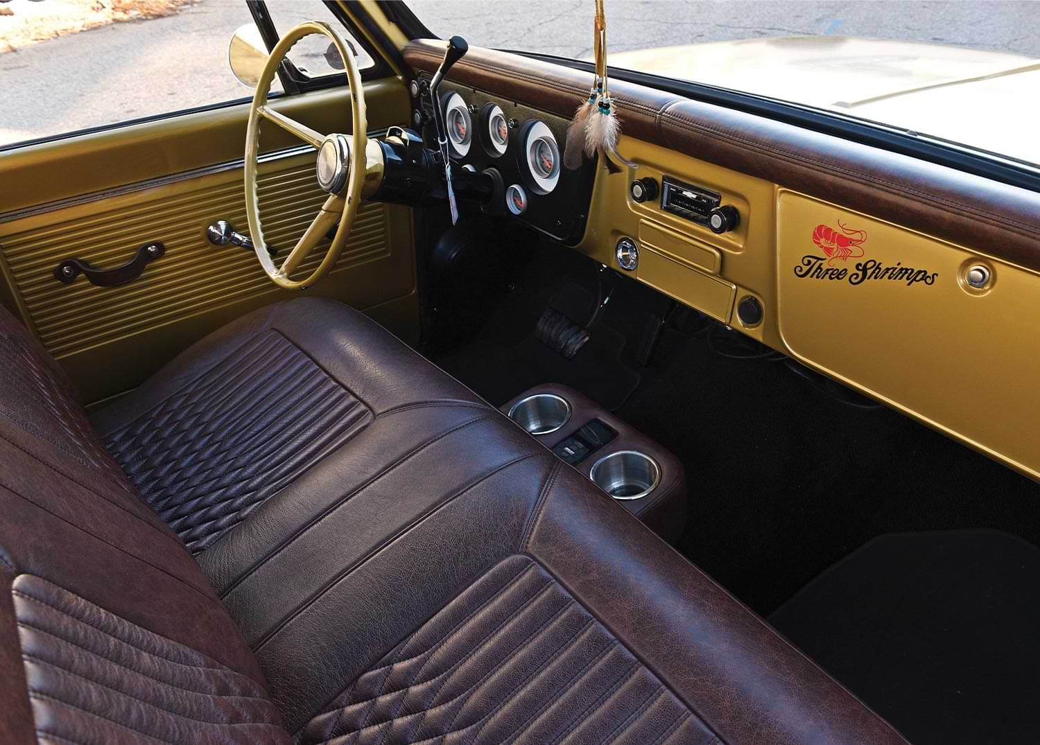 passenger side interior view of the '68 C10, featuring dark brown leather seating and a gold dashboard