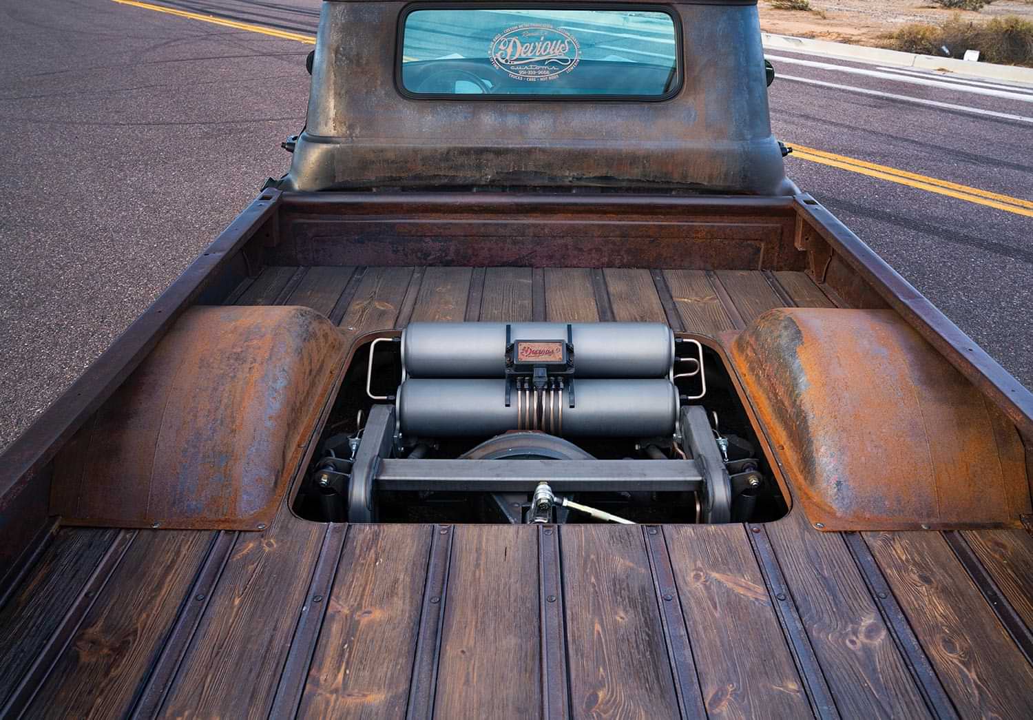 the '59 Apache's raised bed featuring wooden paneling and an air suspension system