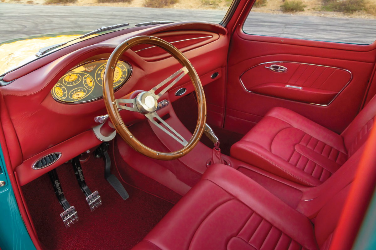 teal '54 Chevy interior view of steering wheel and dashboard