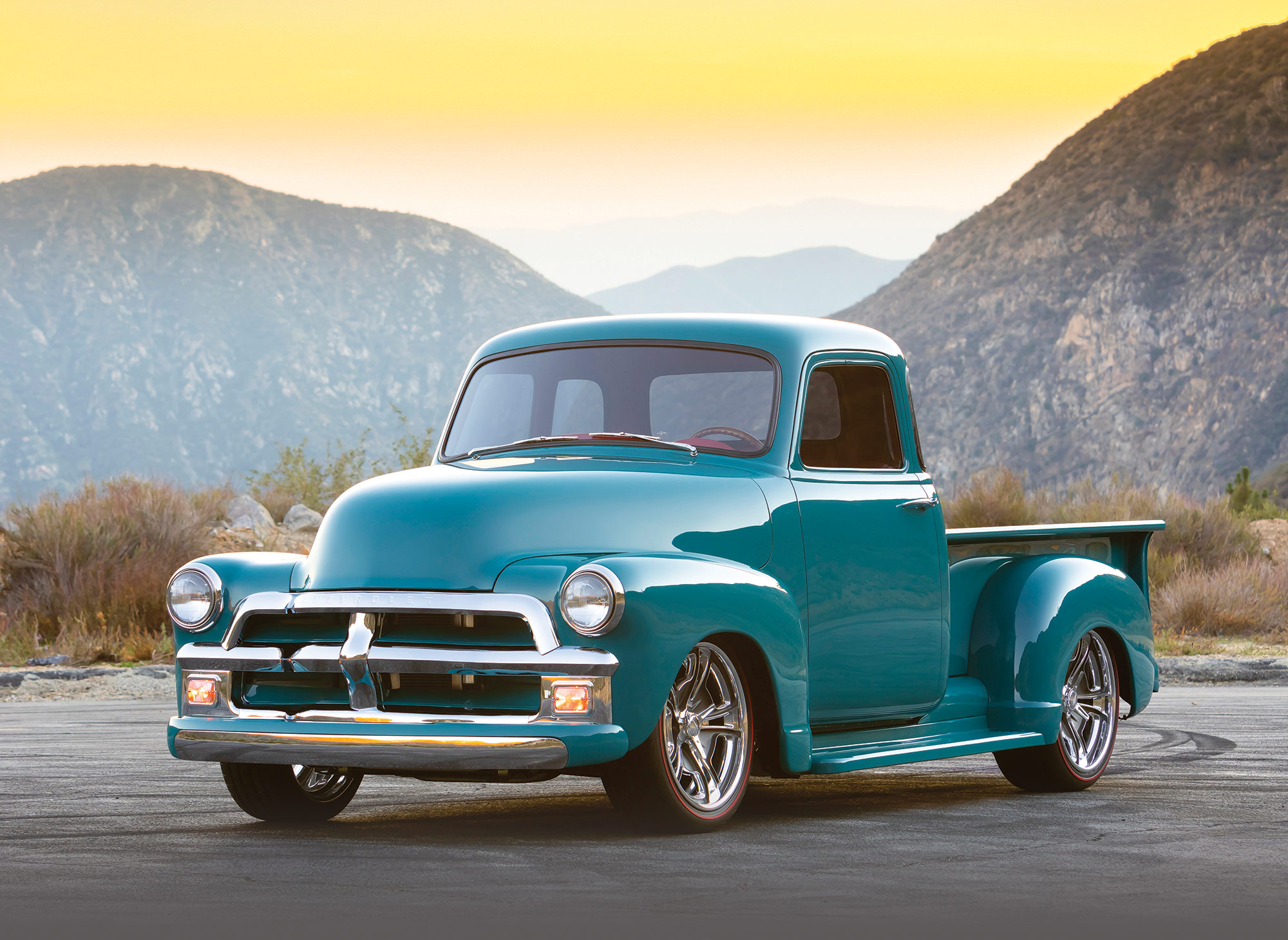 '54 Chevy in the desert with sun setting behind it