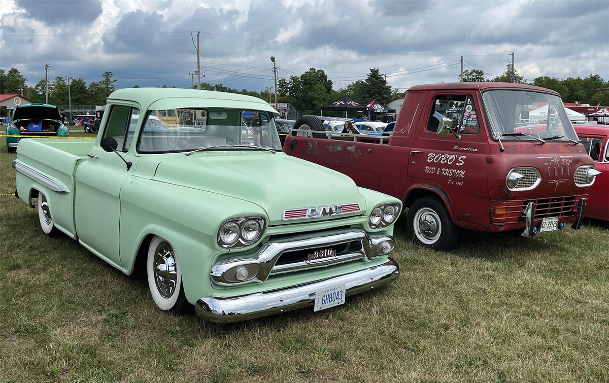 Restored mint green GMC 9310 and patina red Ford Econoline cabover pickup