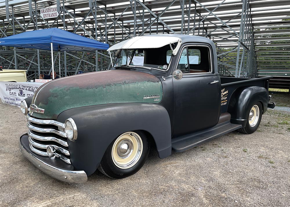 Black Chevy 3100 with patina green hood