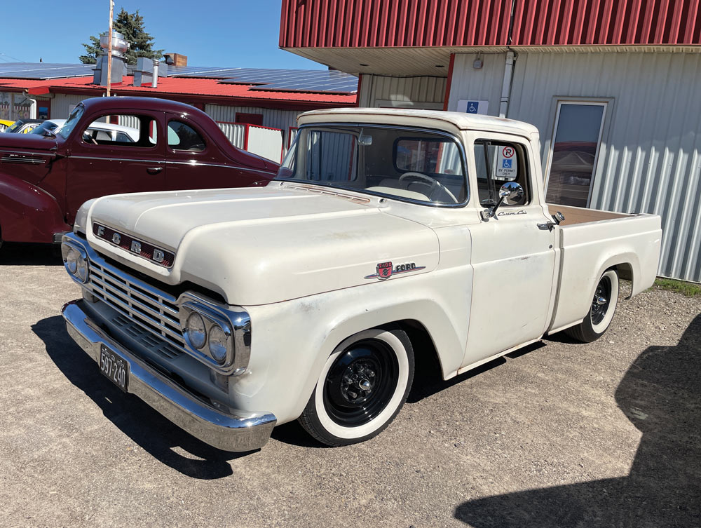 White Ford F-100 on black steelies and whitewalls