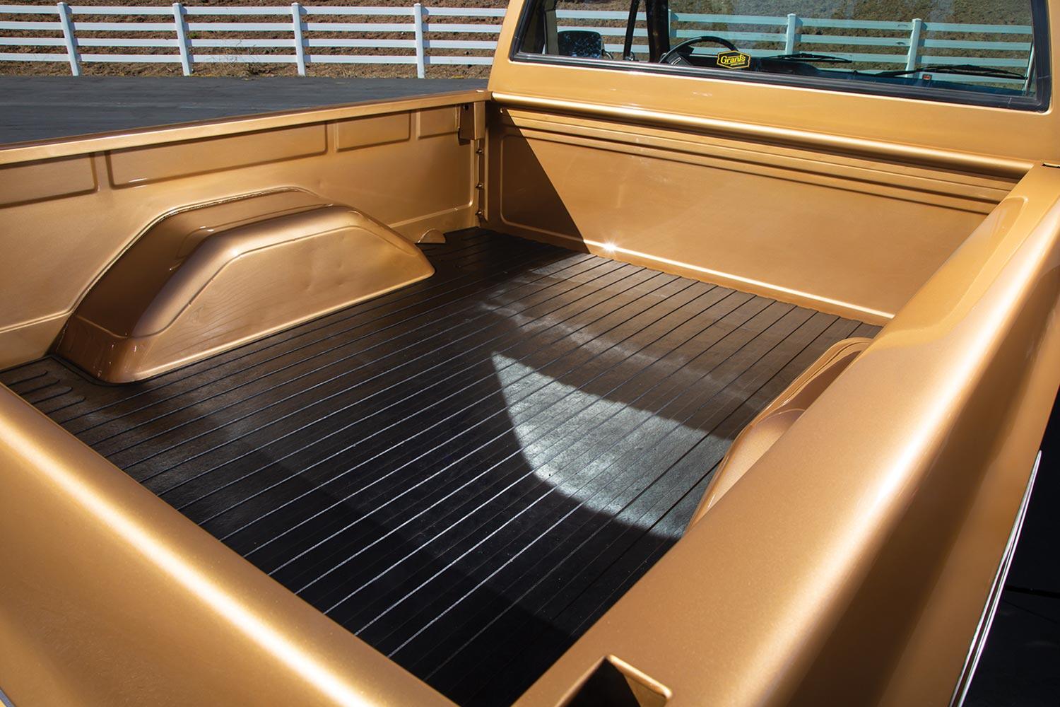 the gold '84 GMC Sierra's trunk bed