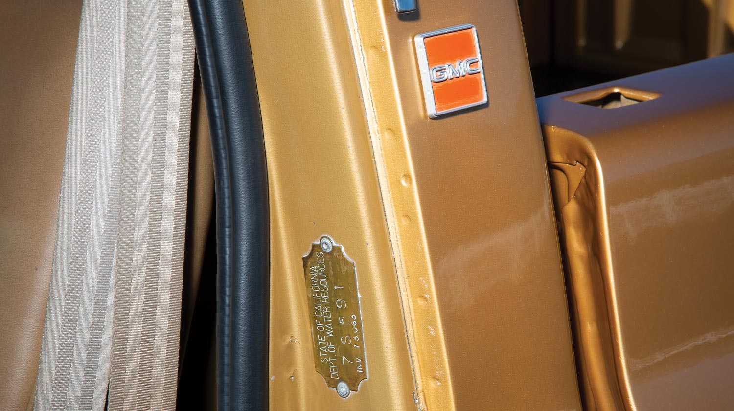 close view of the '84 GMC Sierra's driver door jamb and GMC emblem