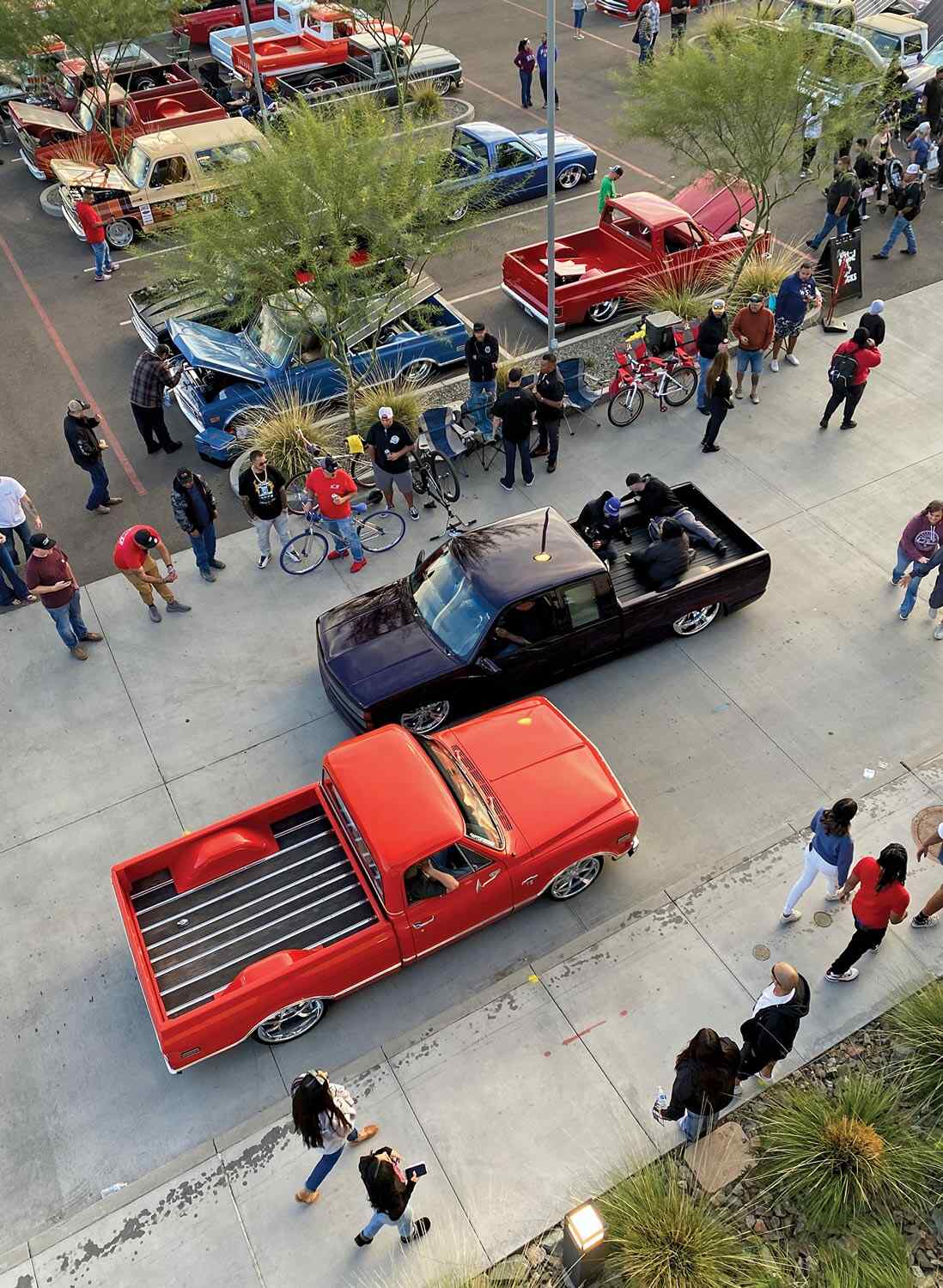 aerial view of a black truck and a red truck parked facing opposite directions at the 12th Dino's Git Down