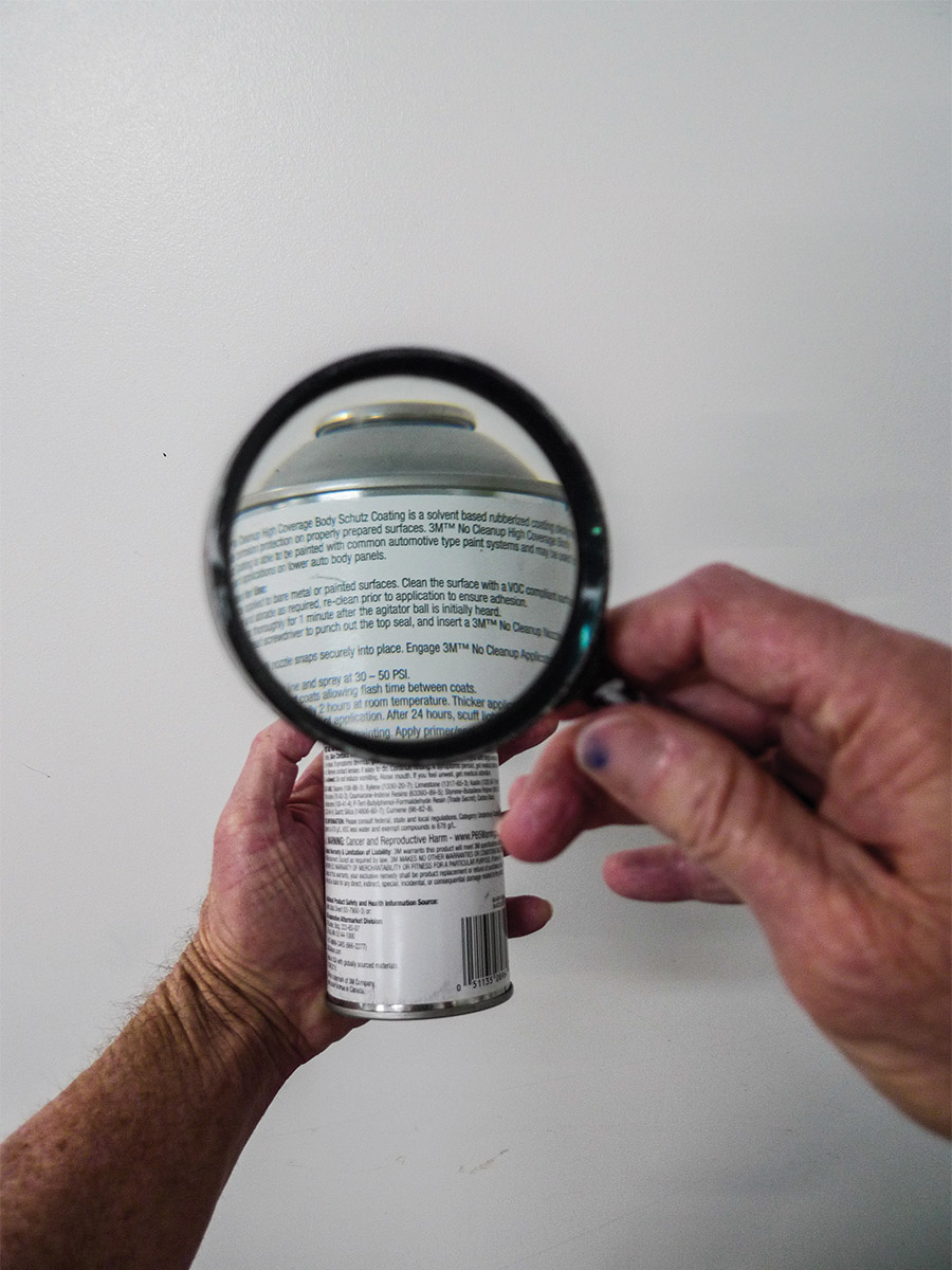 Magnifying glass to spray can