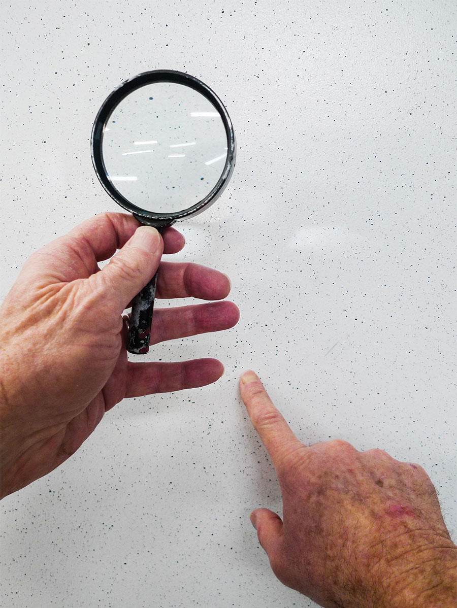 Magnifying glass to splatter on white walls