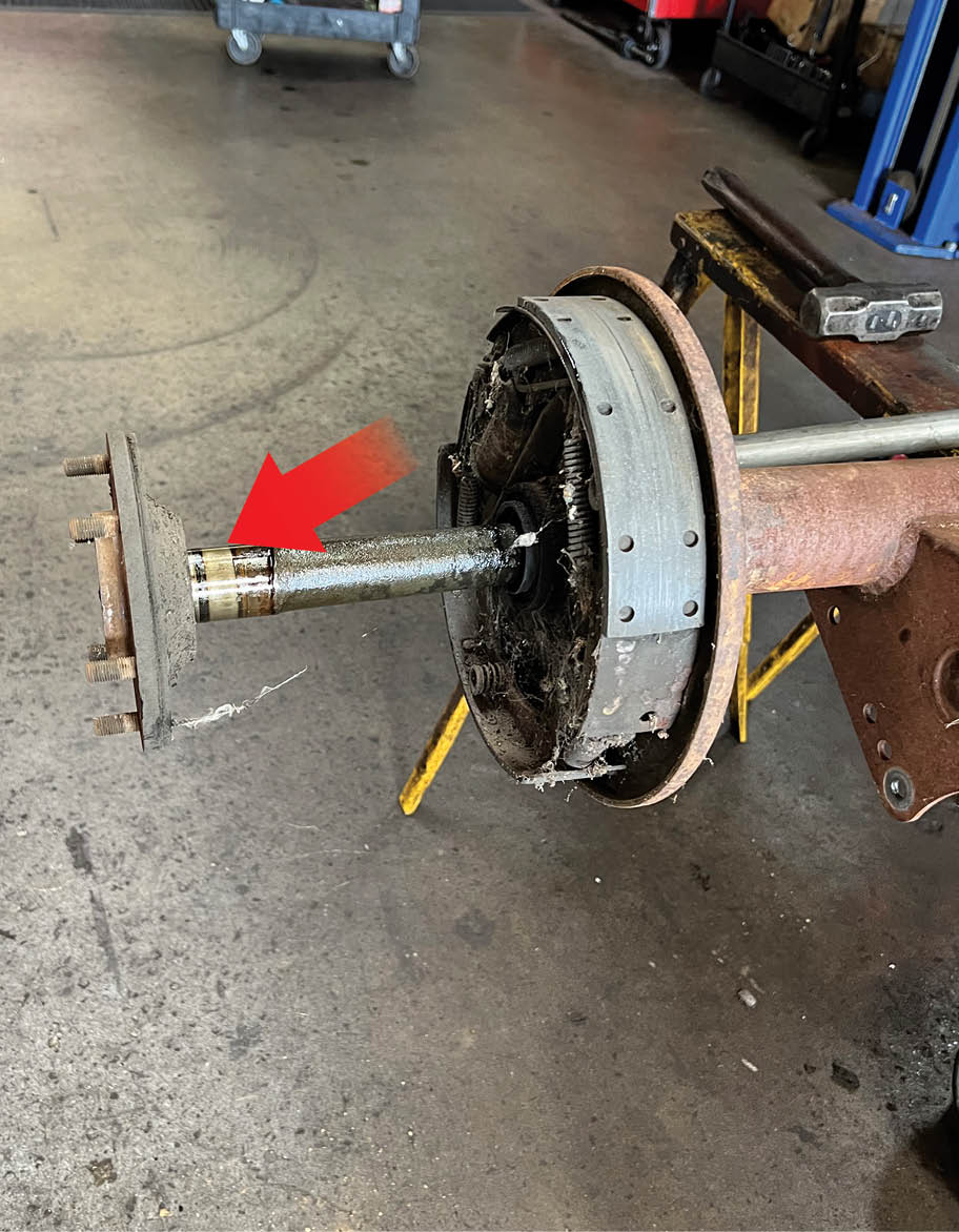 Here one of the six-lug axles is being removed. These rearends use roller bearings that ride directly on the axle (arrow) as there is no inner bearing race.