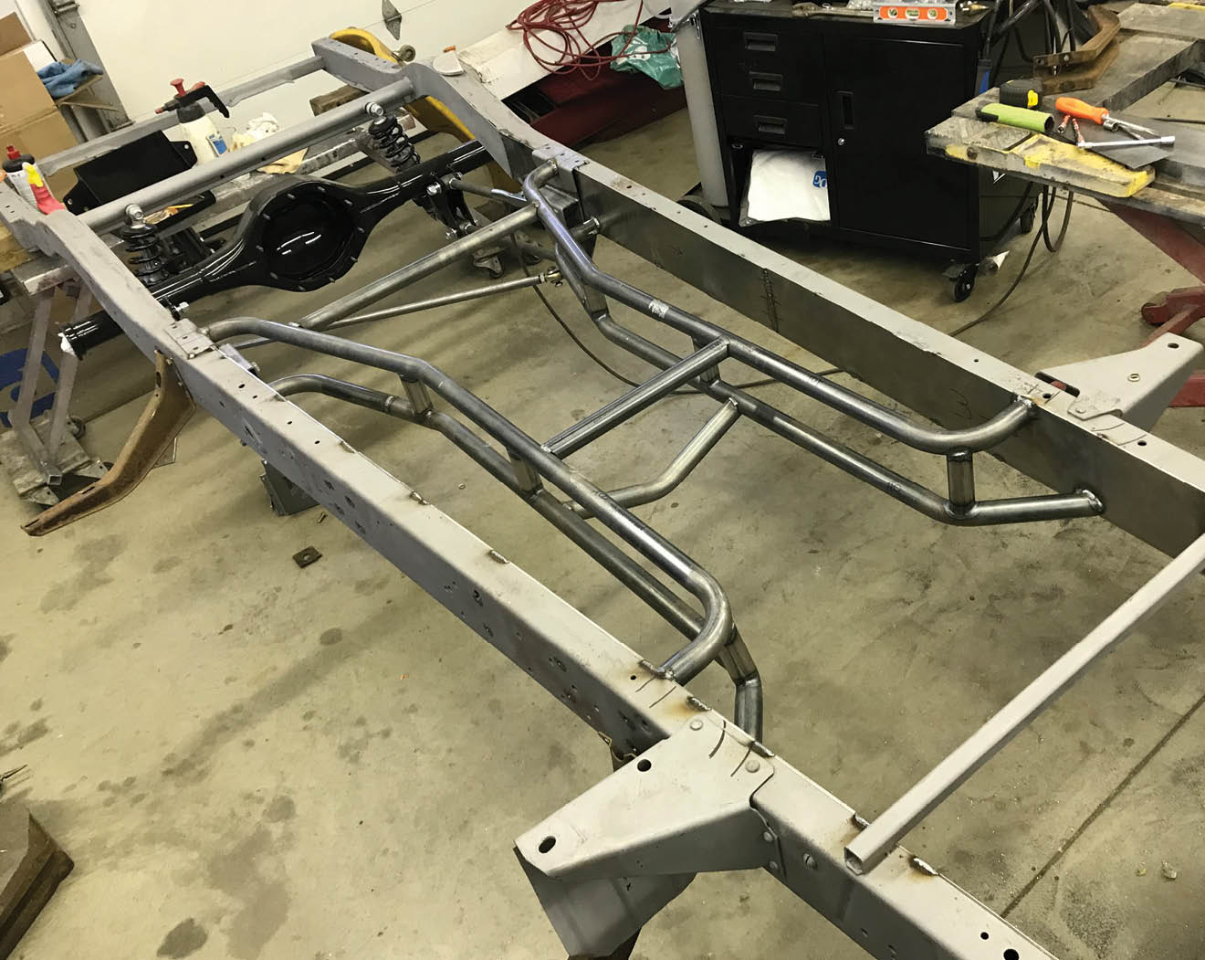 Progressive Automotive supplied the tubular crossmember components. In the rear it ties into the frame just above the four-bar brackets.