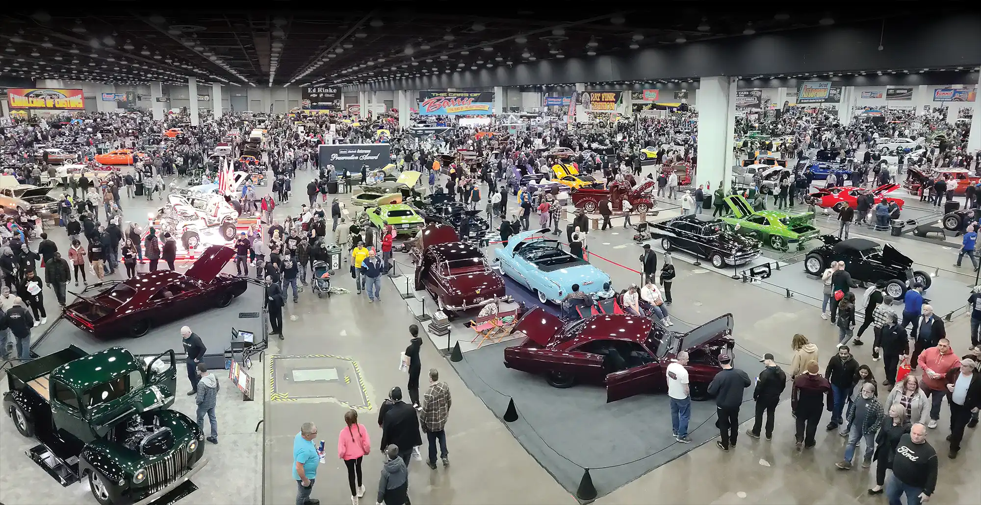 Show floor covered in vehicles and attendees at the 70th Autorama