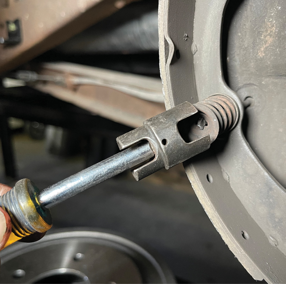 As the spring comes off you’ll want to rotate it around to disengage the adjuster screw assembly and its spring.
