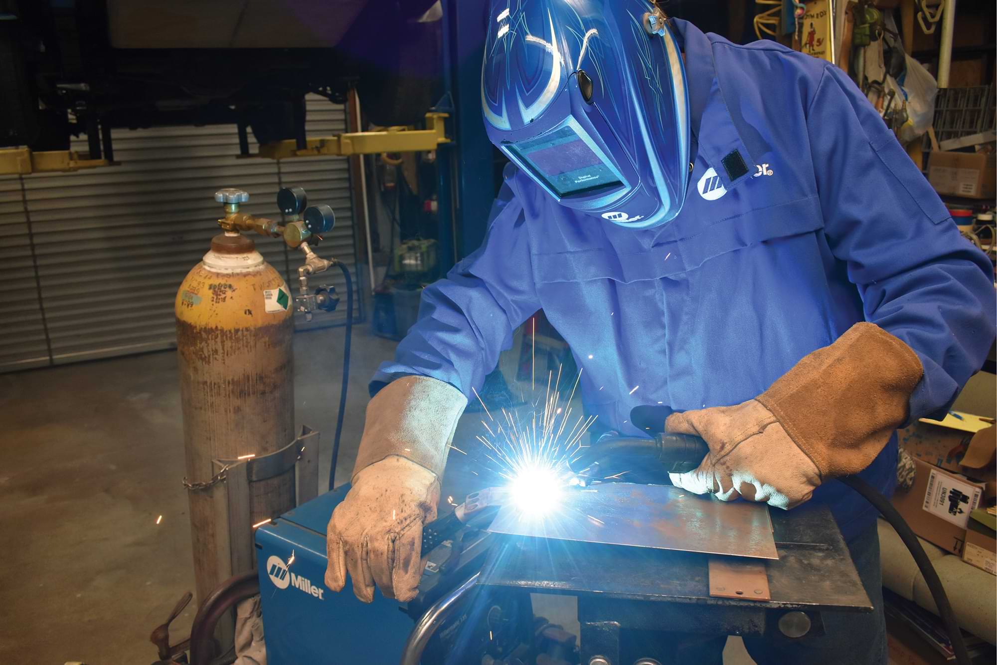 Paul Wilson prepared for welding up holes in his ’52 Chevy pickup by adjusting his Miller Electric Manufacturing Company MIG welder on a scrap piece of sheetmetal.