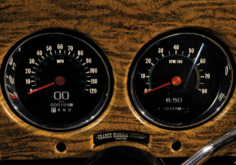 close up of a black speedometer with a black and orange texture pattern surrounding