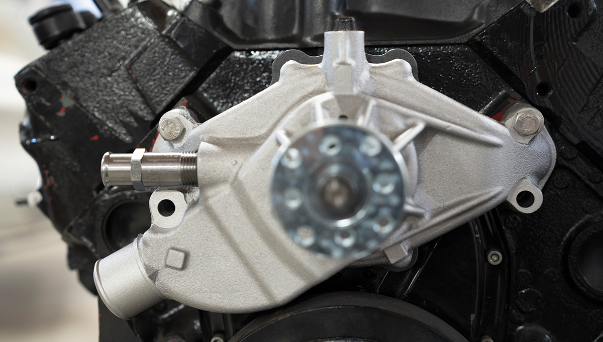 When installing the water pump, there are a couple different ways of going about attaching the gaskets—as long as you do so in a manner that “seals” the pump to the block you’re good! Use just the upper two (temporary) mounting bolts, but do not fully tighten yet.