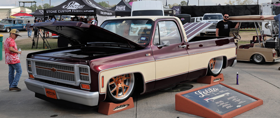 red and tan truck with hood open