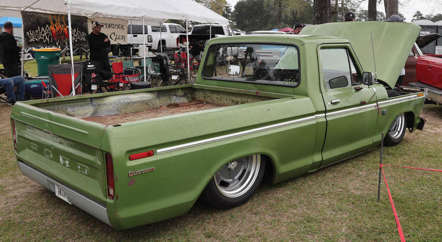 green truck with hood open