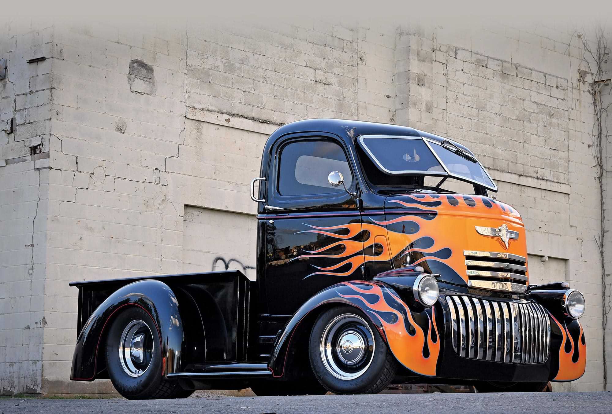 3/4th passenger side view of Mike Di Maulo's black '45 Chevy COE with red trim and a front flame paint job