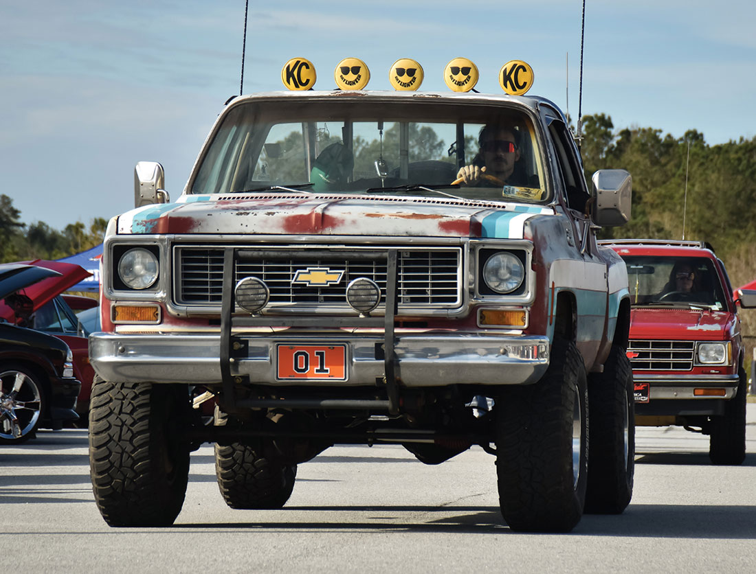 Lifted Squarebody stepside with vintage KC Daylighters on rollbar