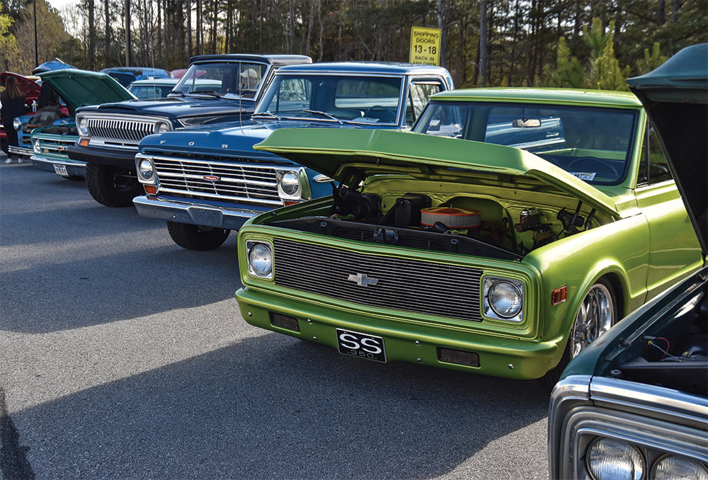 Row of trucks with Kermit green C10 in foreground