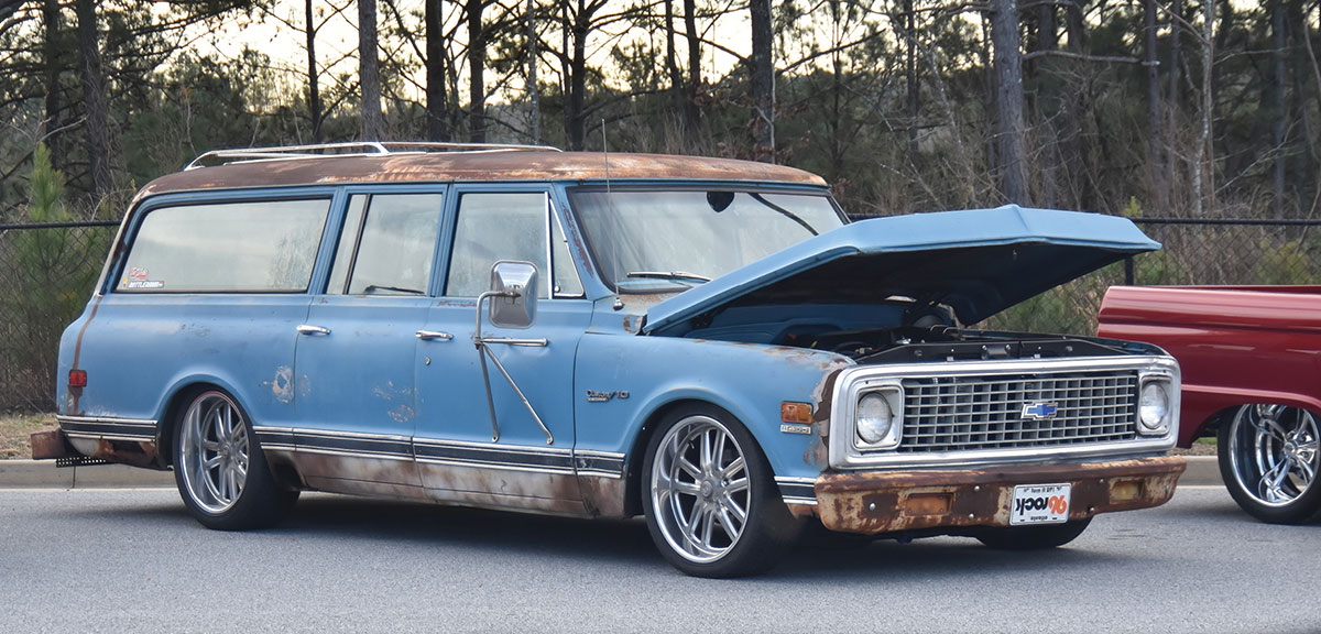 Rusty patina powder blue Suburban C10 on custom wheels