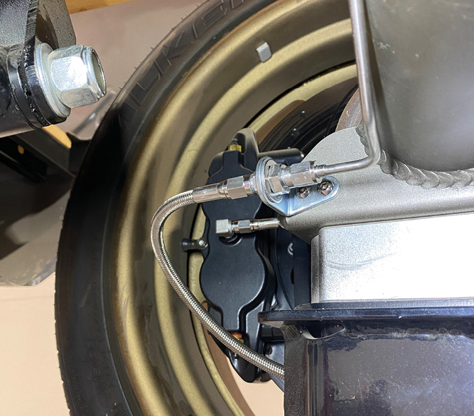 On the rearend itself, a stainless braided hose attaches to each caliper at one end and a bulkhead fitting, mounted to a tab that’s attached to the rearend housing, at the other. This lends for easy maintenance of the calipers in the case of brake pad replacement, and so on.