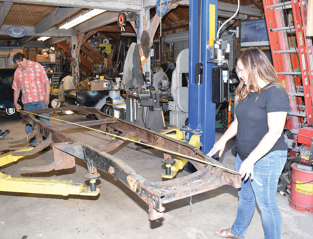 Paul Wilson and Merissa Ceridono cross measuring the frame