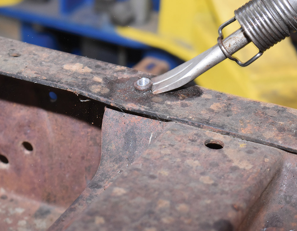Knocking out rivets with air chisel