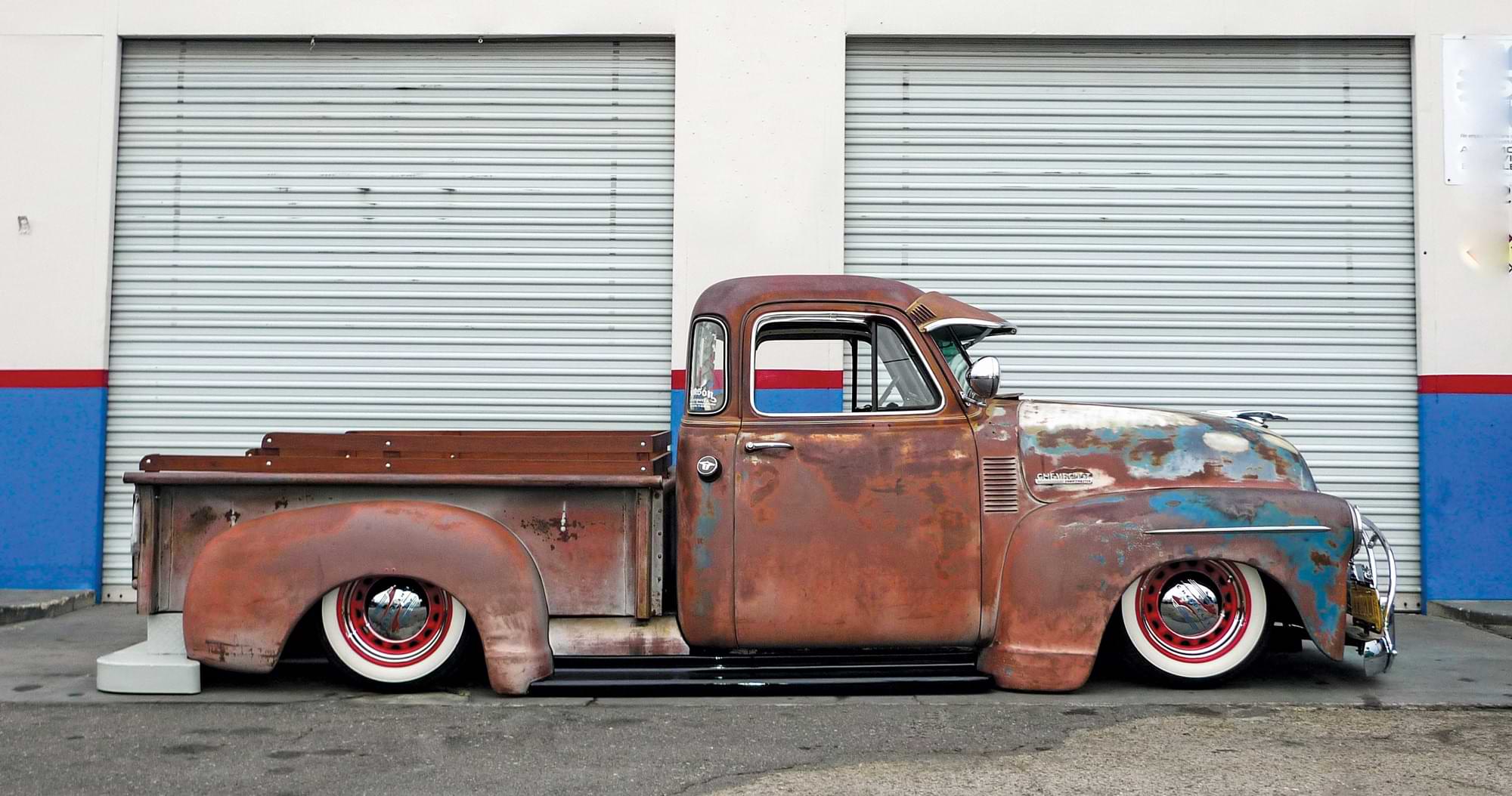 side profile of chevy truck with rusty paint job