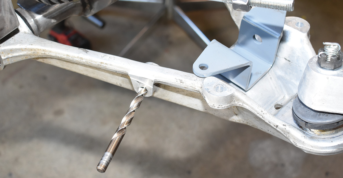 The optional Flat Out Engineering sway bar bracket attaches to the factory hole in the front of the control arms after they are drilled to 3/8 inch.