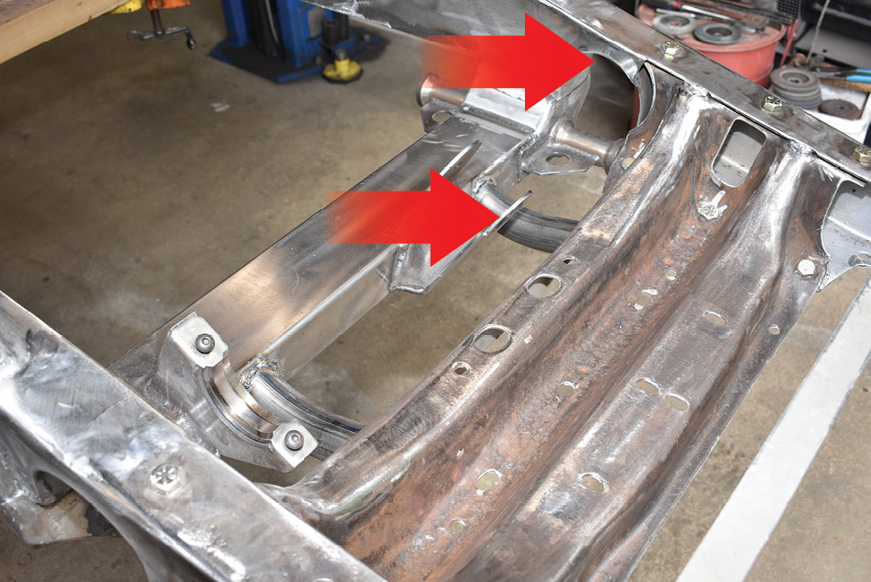 Here the notches have had the C-notches filled in and the front Flat Out Engineering boxing plates have been added, as can be seen on the left framerail (<i>top arrow</i>).  Note the added reinforcements (<i>bottom arrow</i>) to support the front crossmember.