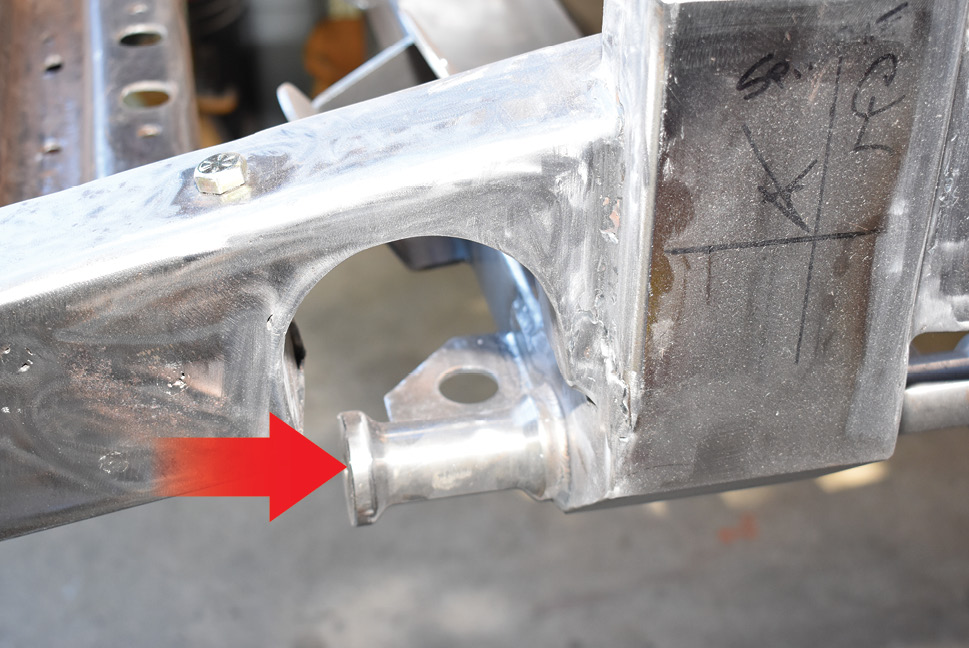 This is the finished C-notch in the left framerail from the outside. The lower control arm mount (arrow) isn’t as close to the bottom of the C-notch as it appeared. 