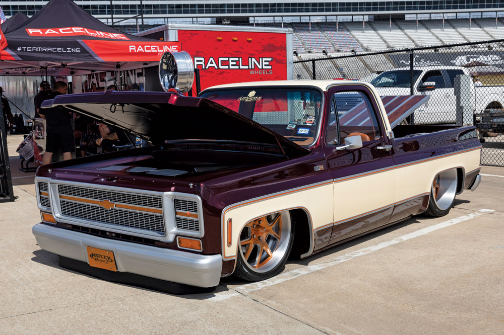 Slammed deep maroon and cream Squarebody with custom hideaway lights