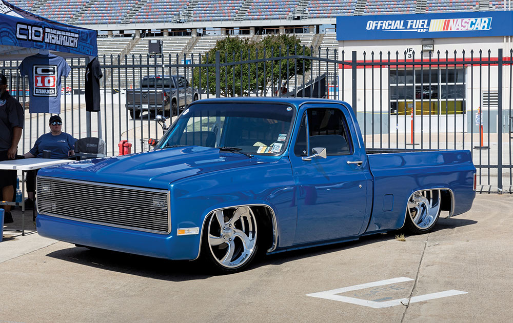 Slammed blue Squarebody with cowl hood and bumper deletes