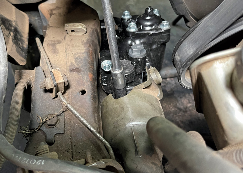 With the box mounted, we connected the steering rag joint to the shaft by sliding it into position. There’s a relief on the shaft that allows the bolt to go through to help secure the connection. Once aligned, tighten the bolt.