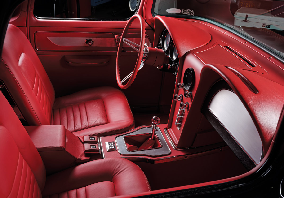 red dashboard, steering wheel, and leather interior in a '57 Chevy