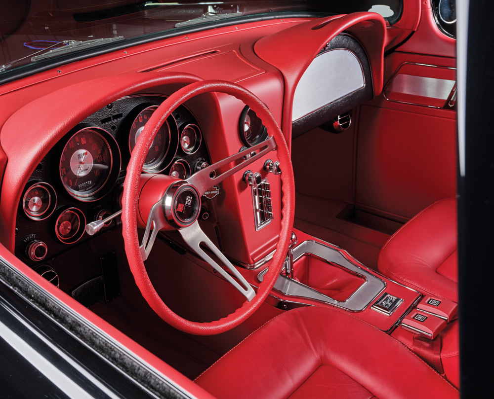 red dashboard, steering wheel, and leather interior in a '57 Chevy