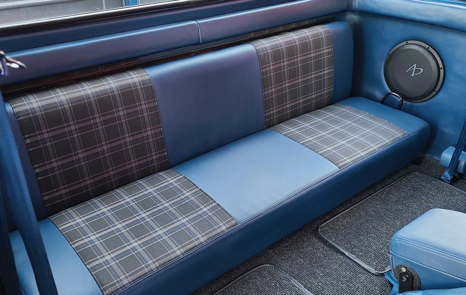the ’75 Ford SuperCab rear seating finished with blue leather and grey plaid accenting
