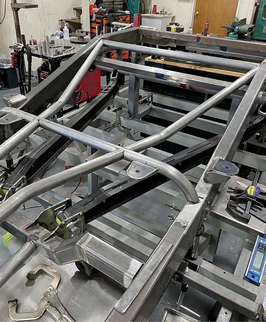 The round tubing chassis members are being fitted to the framerails.