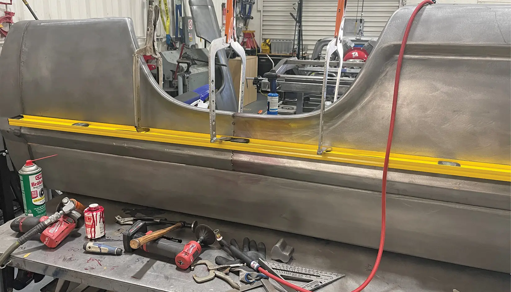 After cutting and fitting, the bed sections are clamped together with a rigid straightedge as they are tack-welded back together.